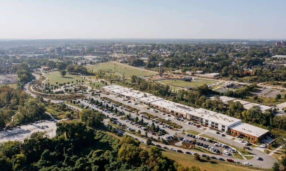 Aerial view of a commercial complex with parking, roads, and surrounding green space relevant to an ALTA land survey