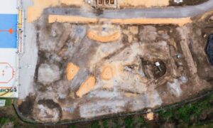 Aerial view of a construction site with graded terrain and building areas during an elevation survey