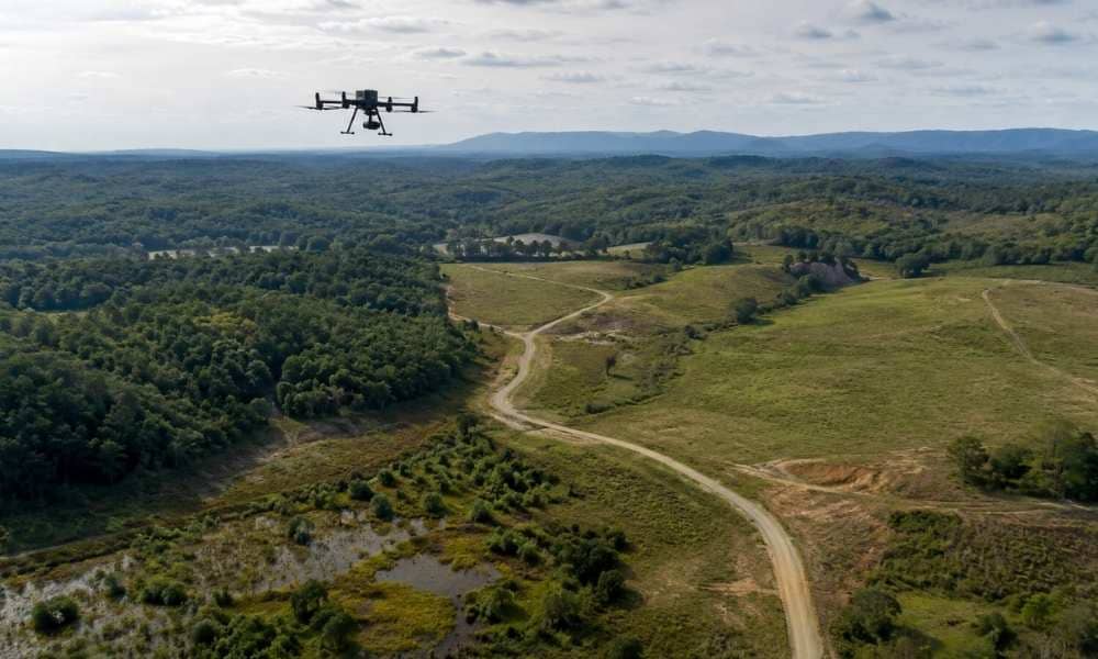 Drone LiDAR mapping over a wooded Virginia land development site with open terrain, access roads, and drainage features