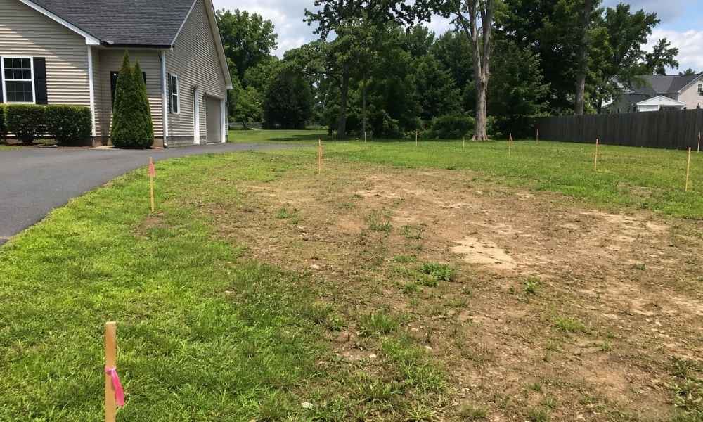 Residential lot in Virginia marked with survey stakes before construction begins